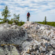 Li-FT geologist stands atop exposed spodumene outcrop at YPP.