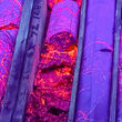 Silver-rich massive sulfides in Waterpump drill core glow pink under UV light.