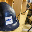 Blue hardhat with BMC logo on a shelf at the Kudz Ze Kayah project in the Yukon.