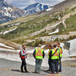 Fireweed Metals crew holding a briefing on a slope at Macmillan Pass, Yukon.