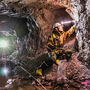 A geologist grabs samples from the walls of a historic underground silver mine.