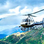 An ATAC helicopter flying through the beautiful mountainous valley's of Yukon.