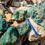 A pile of boulders oxidized green from high-grade copper mineralization.