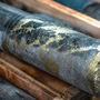 Grey drill core riddled with high-grade copper and gold mineralization.