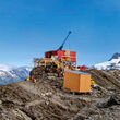 A drill rig tests for gold from a mountain ridge in Northern British Columbia.