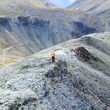 Geologist walking along the crest of a hill at Fireweed Metal's Macmillan Pass.
