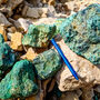 A collection of rocks stained green from high-grade copper mineralization.