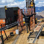 With an Alaska mountain backdrop, a driller waves from a pad at RPM North.