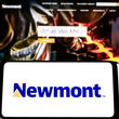 A smartphone displays Newmont’s logo in front of mining company’s webpage.