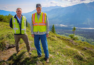 Mining executive and Alaska governor on a ridge overlooking the Skwentna River.