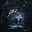 Three workers walk through tunnel at historical underground mining at Premier.