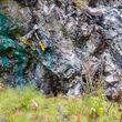 A geologist investigates a copper-stained outcrop in BC’s Golden Triangle.