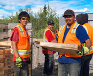 Young Alaska Natives from Tetlin carry boxes of core from drilling at Manh Choh.