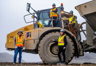 Tahltan equipment operators with an articulating truck used in mining.