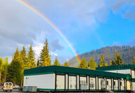 A rainbow shines down over the Palmer project camp in Alaska.