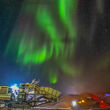 Burst of green northern lights over a crusher at the Nechalacho rare earth mine.