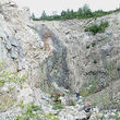 Man stands in a ravine of the old Little Chief mine near Whitehorse, Yukon.