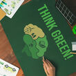 People gathered around a table covered with a mat that says, “THINK GREEN!”