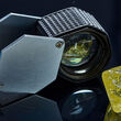 A geologist loupe and yellow diamond recovered from the Gahcho Kué Mine.