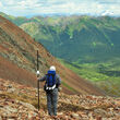 Geologist surveying on a slope overseeing the Rogue property in Yukon.