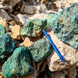 A rind of green malachite (copper carbonate) covers rocks collected at Storm.