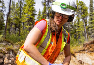 Female technician with a section of drill core at the Turnagain nickel project.
