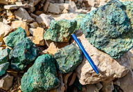 A rind of green malachite (copper carbonate) covers rocks collected at Storm.