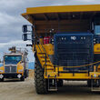 A large Cat mine truck, water truck, and dozer at the Manh Choh gold mine.