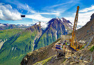 A drill perched on the side of a mountain tests for metals in SE Alaska.