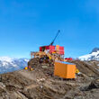 A drill rig sits atop a rocky ridge in the mountains of BC’s Golden Triangle.