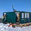A drill tests for high-grade copper on a flat snow-covered expanse in Nunavut.
