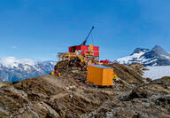 A drill tests for gold from atop a mountain ridge in Northern British Columbia.