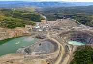 Looking across a mining pit and tailings facility to the Minto camp and mill.