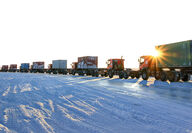 Convoy of trucks cross frozen landscape on its way to eastern Russia gold mine.