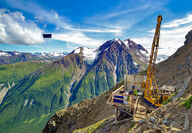 A drill tests for high-grade VMS mineralization from a mountainside at Palmer.