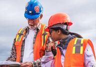 Geologists go over maps during an Alaska gold project visit.