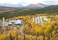A mining headframe and tent camp amongst fall foliage in Northwest Alaska.