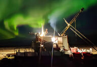 Northern lights above a rig drilling at night at a gold mine project in Nunavut.