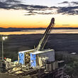 A colorful sunset backdrops a drill at the Graphite Creek project in Alaska.