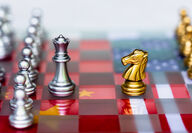 Chess board underlain by China and US flags representing strategic positioning.