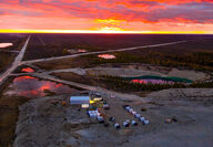 Aerial photo of the sunset on the horizon overlooking the Pine Point mining camp