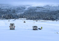 Trucks parked on the frozen Liard River at the Prairie Creek Mine road crossing.
