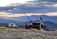 Sun sets behind a drill testing for gold and silver on a ridge in Northern BC.