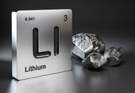 Rocks representing lithium beside a tile with lithium's periodic table data.