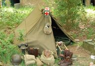 Military tent treated with stibnite antimony fire retardant
