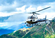 An ATAC helicopter flying through the beautiful mountainous valley's of Yukon.