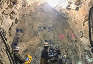 Underground miners working at the face of the Enserch tunnel at Lucky Shot.
