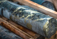 Grey drill core riddled with high-grade copper and gold mineralization.