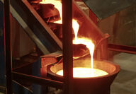 Molten gold cascades down bar molds during a gold pour at the Pogo Mine.