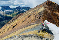 Helicopter perched along the crest of a mountain in Canada’s Yukon.